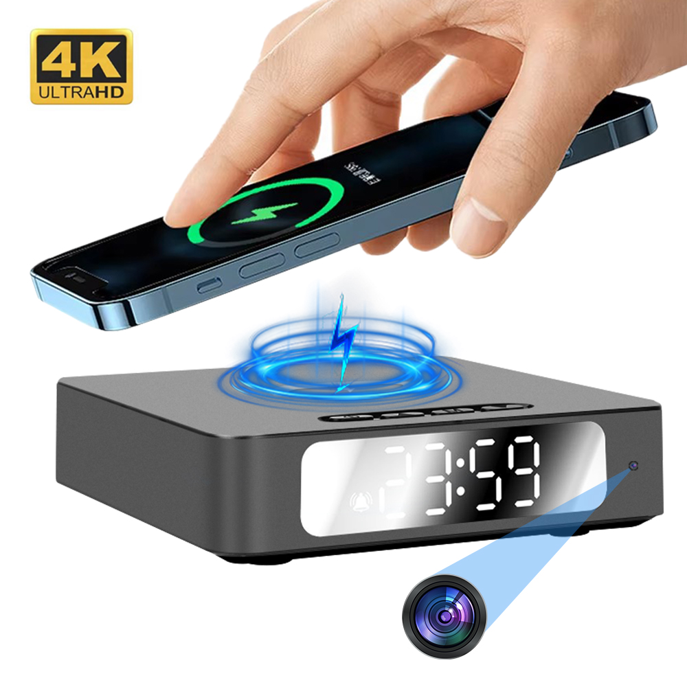 A hand places a smartphone on the Wireless Charger Clock SpyCam, a digital clock charger with a hidden camera, motion detection, and 4K Ultra HD label.